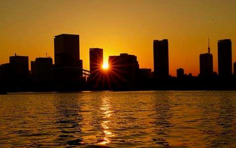 ビルの影に夕日が沈む